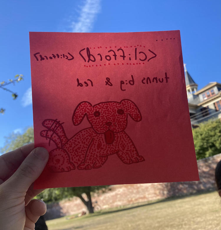 a sheet of origami paper illustrated with a drawing of a spotted red dog