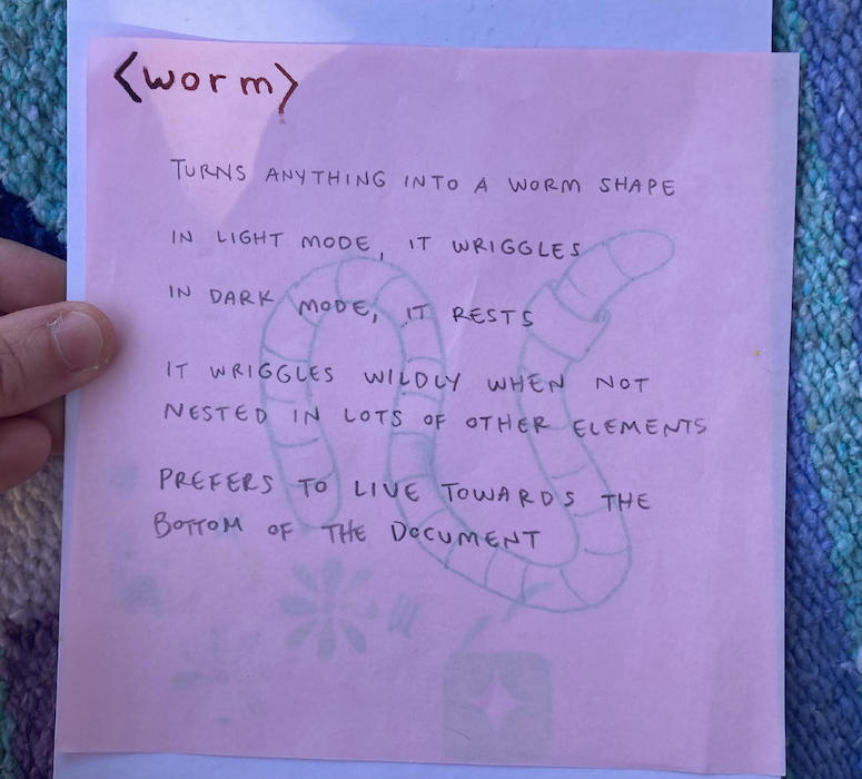 a sheet of origami paper with text describing the worm element