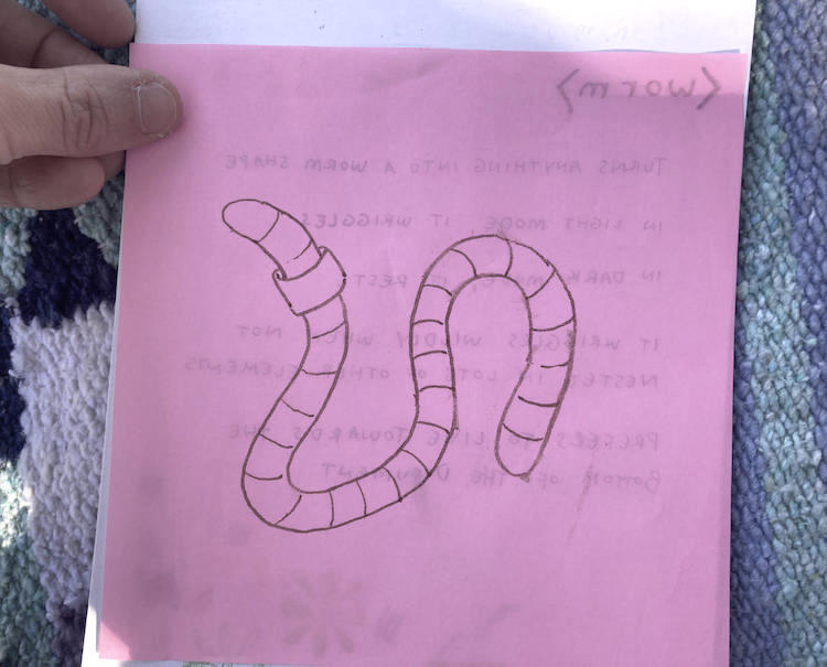 a sheet of origami paper illustrated with a worm